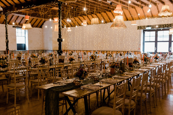 Long wedding meal tables with rustic decor